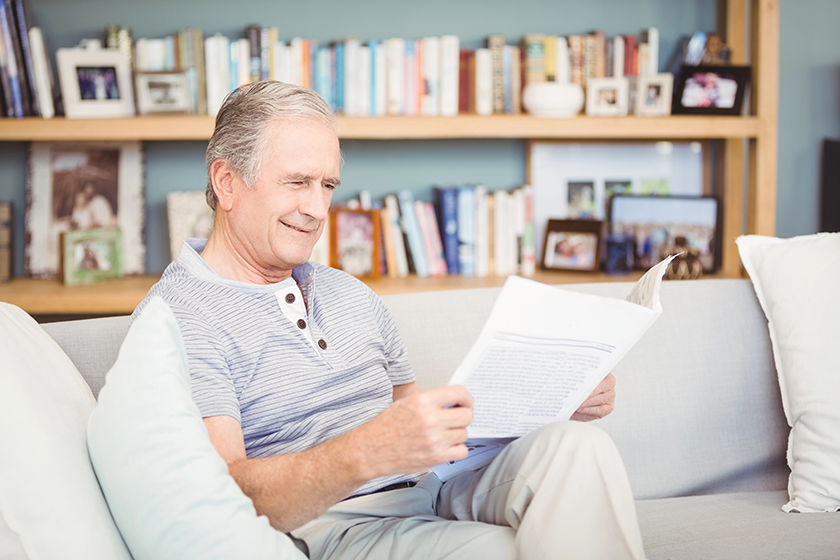 Senior man reading newspaper